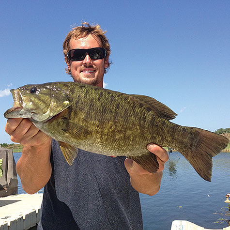 image of a fisherman proudly holding a fish