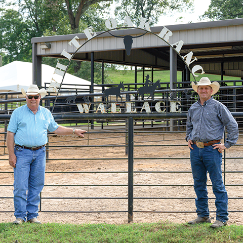 White Oak Ranch owner Freddie Wallace and manager Dustin Kennedy in front of the ranch sign  image
